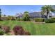 Expansive backyard featuring lush greenery, mature landscaping, and a view of the home's screened-in pool area at 6702 Drewrys Blf, Bradenton, FL 34203