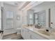 Modern bathroom with a double vanity, glass-enclosed shower, and plenty of natural light at 6702 Drewrys Blf, Bradenton, FL 34203