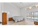 Bright bedroom with pool views, sliding doors, neutral decor, and a ceiling fan at 6702 Drewrys Blf, Bradenton, FL 34203