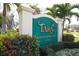 An elegant community sign surrounded by colorful flowers and lush greenery at 6702 Drewrys Blf, Bradenton, FL 34203