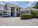Inviting two-story home with manicured lawn and blue front door at 6702 Drewrys Blf, Bradenton, FL 34203