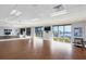 Light-filled fitness room with wood floors, floor-to-ceiling mirrors, and views of the water at 6702 Drewrys Blf, Bradenton, FL 34203