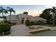 Beautiful home featuring manicured landscaping, a circular driveway with a fountain, and a light gray tile roof at 6702 Drewrys Blf, Bradenton, FL 34203