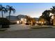 Beautiful home featuring manicured landscaping, a circular driveway with a fountain, and a light gray tile roof at 6702 Drewrys Blf, Bradenton, FL 34203