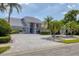 Beautiful single-story home with manicured landscaping, water feature, and long paver driveway at 6702 Drewrys Blf, Bradenton, FL 34203
