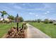 Scenic view of the golf course featuring lush greenery, mature trees, and a cart path at 6702 Drewrys Blf, Bradenton, FL 34203