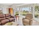 Bright living room showcasing a large window with views, comfortable seating, and natural light at 6702 Drewrys Blf, Bradenton, FL 34203