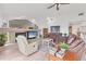 Living room featuring a fireplace, comfortable seating, and bright natural light at 6702 Drewrys Blf, Bradenton, FL 34203