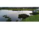 Picturesque pond with a fountain feature and manicured shoreline at 6702 Drewrys Blf, Bradenton, FL 34203
