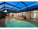 Enclosed patio features a pool, hot tub, and outdoor dining area at 6702 Drewrys Blf, Bradenton, FL 34203