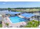 Aerial view of a refreshing community pool with ample seating and shaded areas, perfect for relaxation at 6702 Drewrys Blf, Bradenton, FL 34203