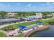 Aerial view of tennis courts, pool and recreation building with beautiful landscaping at 6702 Drewrys Blf, Bradenton, FL 34203