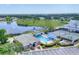 Scenic aerial view showcasing a community pool, tennis courts, and lake, creating a vibrant recreational hub at 6702 Drewrys Blf, Bradenton, FL 34203