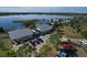 Aerial view of lakefront buildings and facilities, including a marina, parking area, and boat launch, under a blue sky at 6702 Drewrys Blf, Bradenton, FL 34203