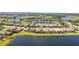 Aerial view of a beautiful community, showcasing homes with water views and lush landscaping on a sunny day at 7120 Quiet Creek Dr, Bradenton, FL 34212