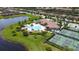 Aerial view of a resort style community featuring a pool, clubhouse, tennis courts, and lake views at 7120 Quiet Creek Dr, Bradenton, FL 34212