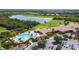 An aerial view showcases the resort style pool, clubhouse, parking and golf course at 7120 Quiet Creek Dr, Bradenton, FL 34212