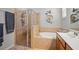 Bright bathroom featuring shower with glass door, tub and double sink vanity at 7120 Quiet Creek Dr, Bradenton, FL 34212