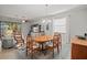 Cozy dining area features a chandelier, and a view of the living room with a stylish entertainment center at 7120 Quiet Creek Dr, Bradenton, FL 34212