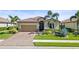 A beautifully landscaped single-Gathering home with a tile roof and a two-car garage at 7120 Quiet Creek Dr, Bradenton, FL 34212