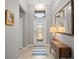 Bright foyer with tiled floors, a decorative mirror, and a console table with a lamp at 7120 Quiet Creek Dr, Bradenton, FL 34212