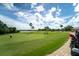 A picturesque view of the golf course on a sunny day with fluffy white clouds in the sky at 7120 Quiet Creek Dr, Bradenton, FL 34212