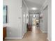 Long hallway with neutral walls, tiled floors, and decorative moldings at 7120 Quiet Creek Dr, Bradenton, FL 34212