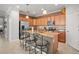 Well-lit kitchen with stainless steel appliances, breakfast bar seating, and granite countertops for modern convenience at 7120 Quiet Creek Dr, Bradenton, FL 34212