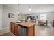 Open kitchen view with granite counters, stainless appliances, seating at the island, and view to the living spaces at 7120 Quiet Creek Dr, Bradenton, FL 34212