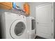 Bright laundry room featuring a Samsung washer and dryer with storage cabinets and shelving at 7120 Quiet Creek Dr, Bradenton, FL 34212