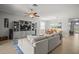 Bright, open living space with neutral tones, tile flooring, and a modern entertainment center for a relaxing ambiance at 7120 Quiet Creek Dr, Bradenton, FL 34212