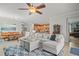 Spacious living room with stylish furniture, a ceiling fan, and an open floor plan at 7120 Quiet Creek Dr, Bradenton, FL 34212