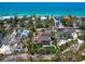 Stunning aerial view of a coastal property with a pool, lush landscaping, and ocean views at 7333 Point Of Rocks Rd, Sarasota, FL 34242