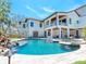 Exterior of the home showing off the pool, patio, and lush landscaping at 7333 Point Of Rocks Rd, Sarasota, FL 34242