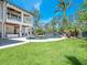 Sprawling backyard featuring a beautiful pool, manicured lawn, and mature trees offering privacy at 7333 Point Of Rocks Rd, Sarasota, FL 34242