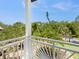 Balcony with white railing overlooking lush tropical landscaping at 7333 Point Of Rocks Rd, Sarasota, FL 34242