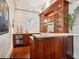 Home bar featuring custom cabinets, a wine refrigerator, and granite countertops at 7333 Point Of Rocks Rd, Sarasota, FL 34242