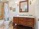 Bathroom vanity with wood drawers and artwork at 7333 Point Of Rocks Rd, Sarasota, FL 34242