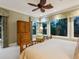 Relaxing bedroom featuring large windows, nature views, and wood dresser at 7333 Point Of Rocks Rd, Sarasota, FL 34242