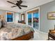 Comfortable bedroom with a ceiling fan, balcony access, and neutral walls at 7333 Point Of Rocks Rd, Sarasota, FL 34242