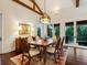 Elegant dining room boasts wood floors, beautiful light fixture and french doors to the outdoor area at 7333 Point Of Rocks Rd, Sarasota, FL 34242
