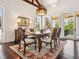 Dining room with wood floors, a decorative chandelier, and multiple windows to the lanai at 7333 Point Of Rocks Rd, Sarasota, FL 34242