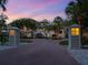 Brick-paved driveway lined with manicured landscaping leading to a beautifully lit home at sunset at 7333 Point Of Rocks Rd, Sarasota, FL 34242