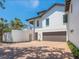 Elegant home featuring a three-car garage, landscaped yard, and a beautiful brick driveway at 7333 Point Of Rocks Rd, Sarasota, FL 34242