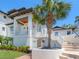 Stunning front exterior featuring a lush palm tree, elegant staircase, and modern architectural design at 7333 Point Of Rocks Rd, Sarasota, FL 34242