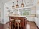 Gourmet kitchen featuring custom cabinetry, granite countertops, a central island, and modern pendant lighting at 7333 Point Of Rocks Rd, Sarasota, FL 34242