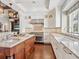 Kitchen with a center island, stainless steel range, and white cabinets at 7333 Point Of Rocks Rd, Sarasota, FL 34242