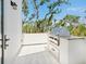 Side porch with a built-in outdoor grill and granite countertop at 7333 Point Of Rocks Rd, Sarasota, FL 34242