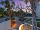 Lush, professionally landscaped yard with lighting highlighting winding brick path at 7333 Point Of Rocks Rd, Sarasota, FL 34242