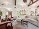 Spacious living room with vaulted ceiling, comfortable seating, and open access to the adjacent kitchen area at 7333 Point Of Rocks Rd, Sarasota, FL 34242